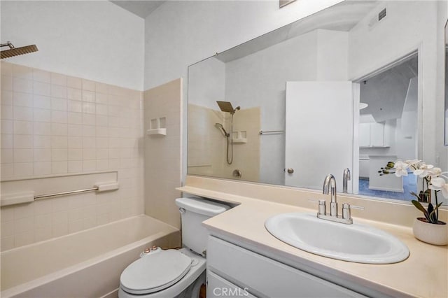 full bathroom with vanity, toilet, and tiled shower / bath