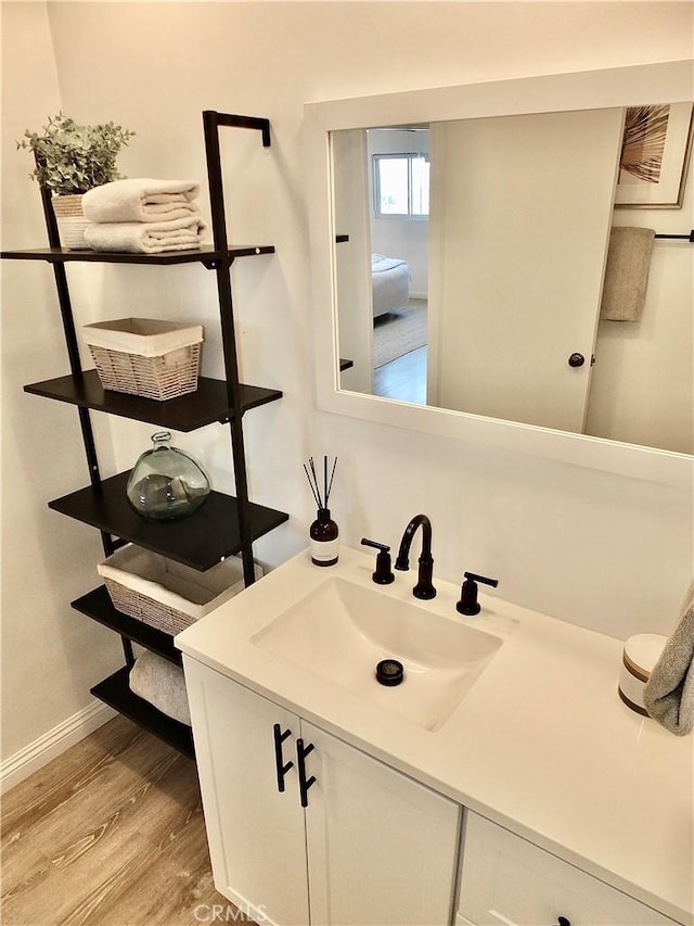 bathroom with hardwood / wood-style floors and vanity