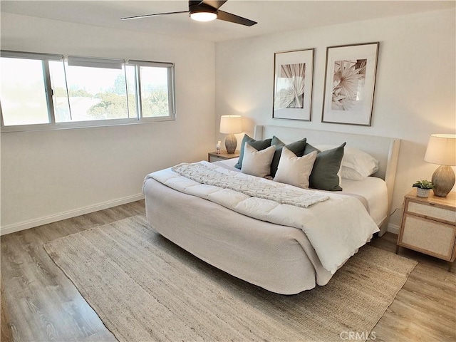 bedroom with ceiling fan and light hardwood / wood-style flooring