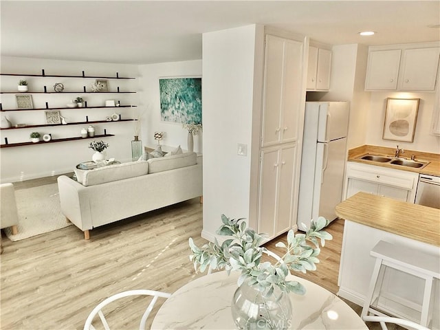 living room featuring light hardwood / wood-style flooring and sink