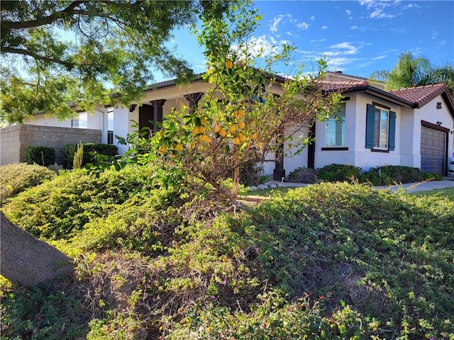 29367 Lytle Ln, Highland, CA 92346 - view of front of property with an attached garage, a tiled roof, and stucco siding