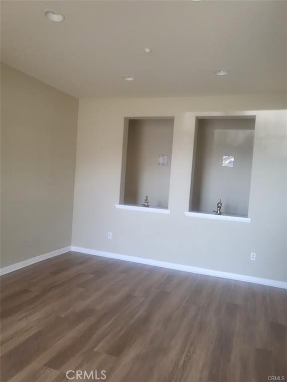 unfurnished room with dark hardwood / wood-style floors