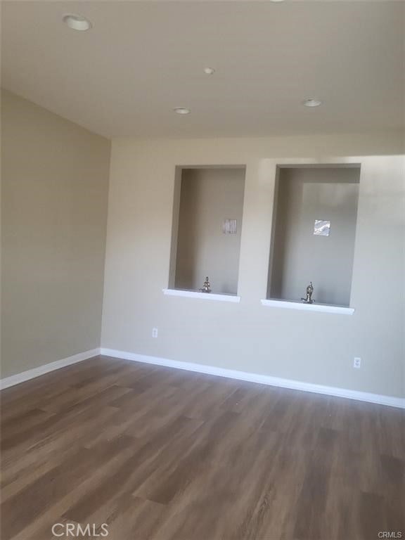 29367 Lytle Ln, Highland, CA 92346 - empty room with recessed lighting, dark wood-type flooring, and baseboards