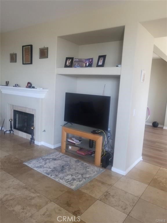 living room with a tile fireplace