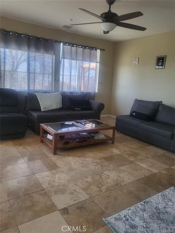 29367 Lytle Ln, Highland, CA 92346 - living area with ceiling fan, baseboards, visible vents, and a healthy amount of sunlight