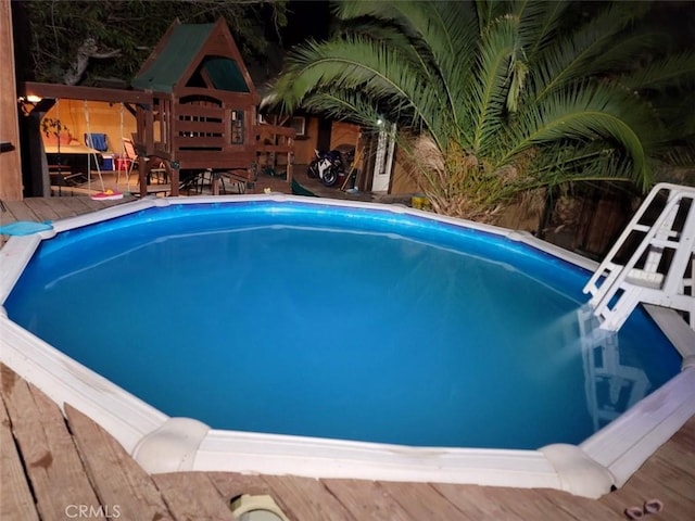 view of swimming pool with a wooden deck