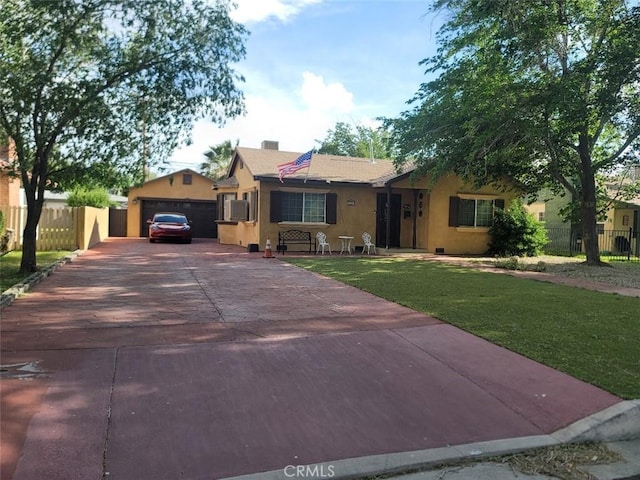 ranch-style house featuring a front yard and a garage