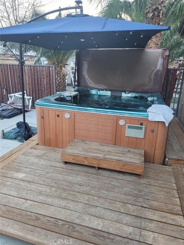 wooden terrace with a hot tub