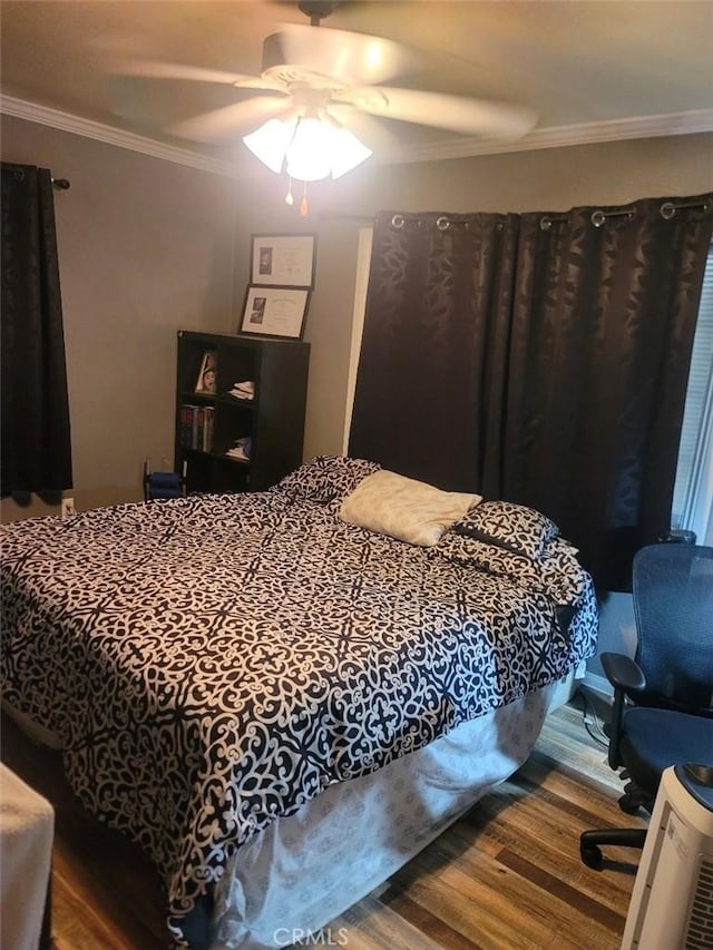 bedroom featuring wood-type flooring, ceiling fan, and ornamental molding