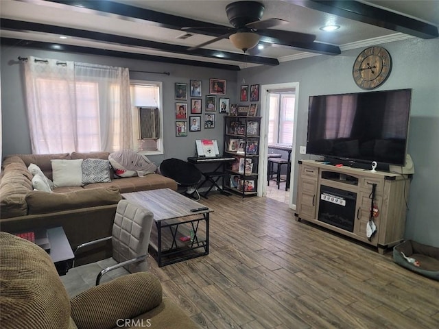 living room with beam ceiling, ceiling fan, hardwood / wood-style floors, and crown molding