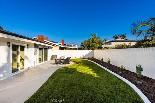 view of yard with a patio and a fenced backyard