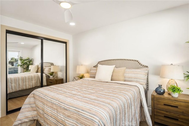 bedroom featuring a closet, wood finished floors, a ceiling fan, and recessed lighting