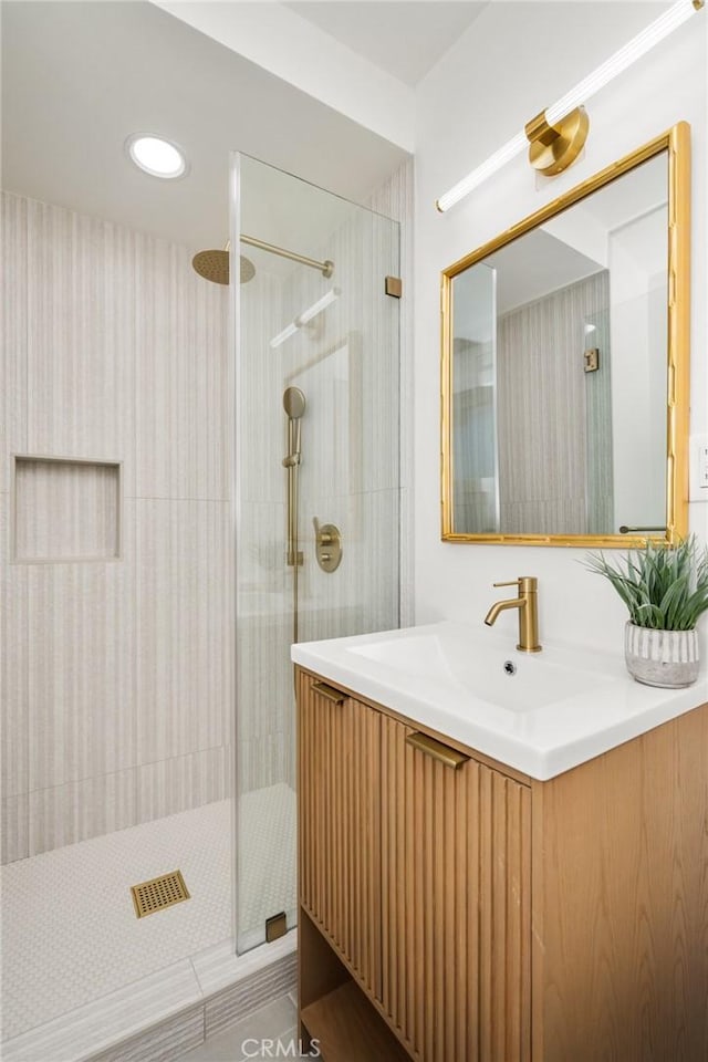 bathroom with vanity and tiled shower