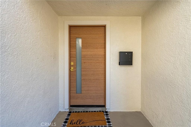 property entrance with stucco siding