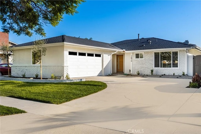 ranch-style home with a front yard and a garage