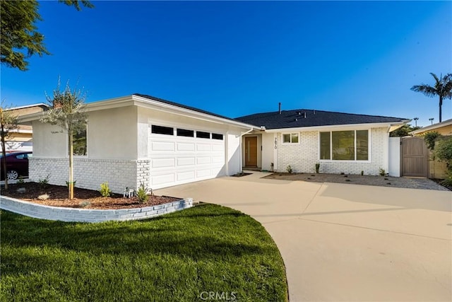 ranch-style house with a garage and a front lawn