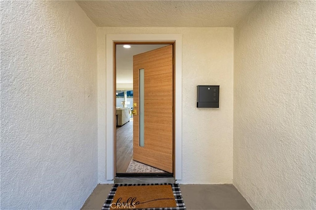 doorway to property featuring stucco siding