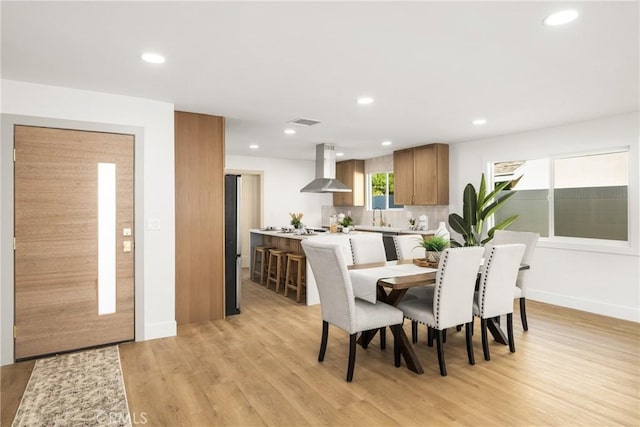 dining room featuring sink and light wood-type flooring