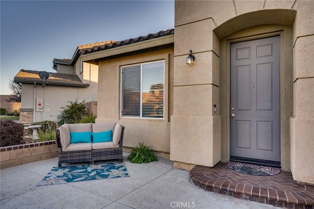 property entrance with a patio