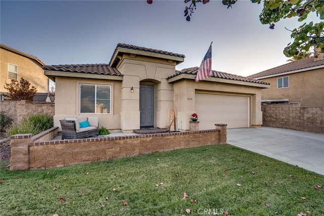 mediterranean / spanish-style house featuring a garage and a front lawn