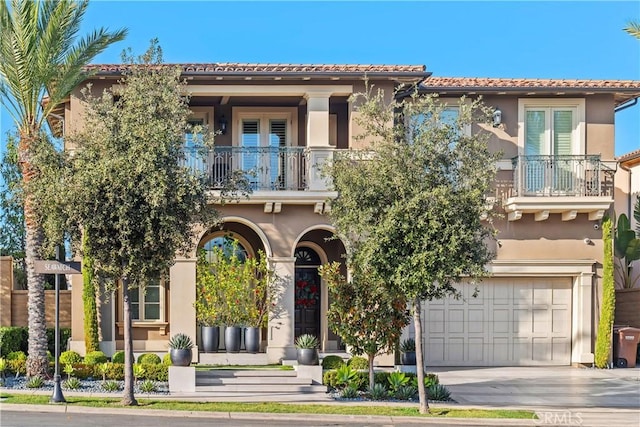 mediterranean / spanish home with a balcony and a garage