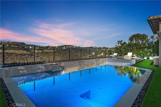 view of pool at dusk