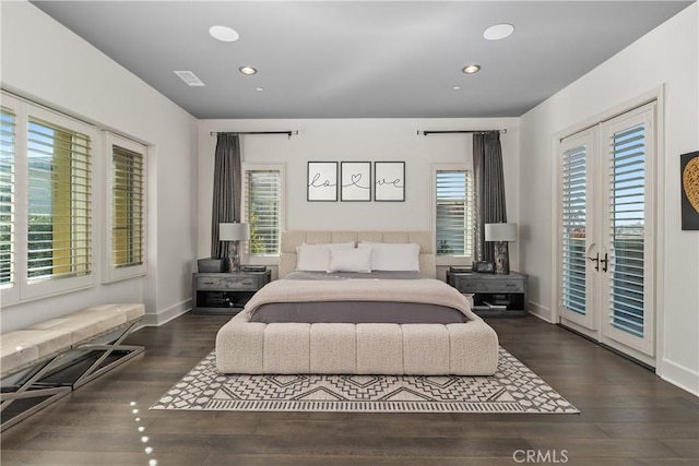 bedroom featuring dark hardwood / wood-style flooring, french doors, access to outside, and multiple windows