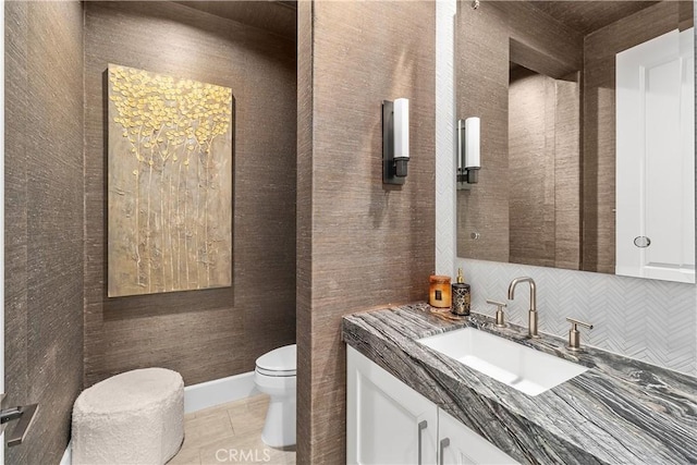 bathroom featuring tile patterned flooring, vanity, and toilet