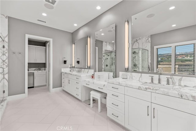 bathroom with tile patterned flooring, vanity, and a shower with shower door