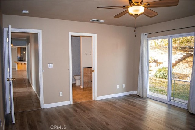 35777 Rd 606, Raymond, CA 93653 - unfurnished bedroom with access to outside, baseboards, dark wood-style floors, and connected bathroom
