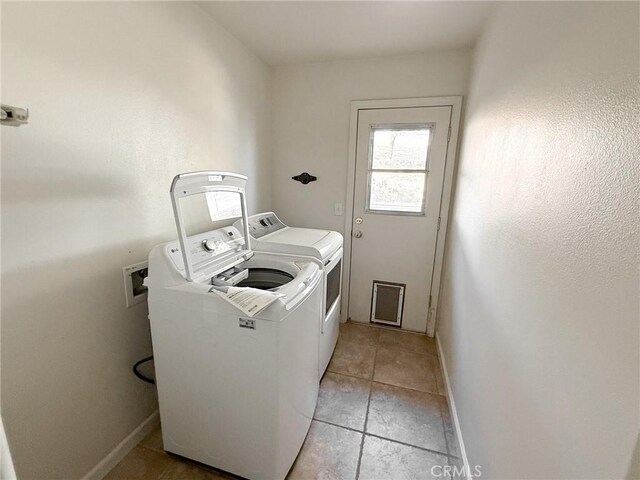 35777 Rd 606, Raymond, CA 93653 - washroom with washing machine and dryer, baseboards, and light tile patterned floors