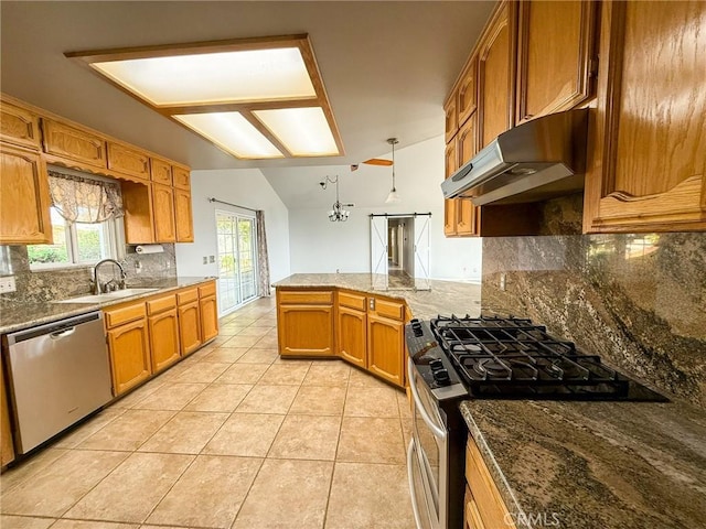 35777 Rd 606, Raymond, CA 93653 - kitchen featuring appliances with stainless steel finishes, under cabinet range hood, a peninsula, tasteful backsplash, and light tile patterned floors