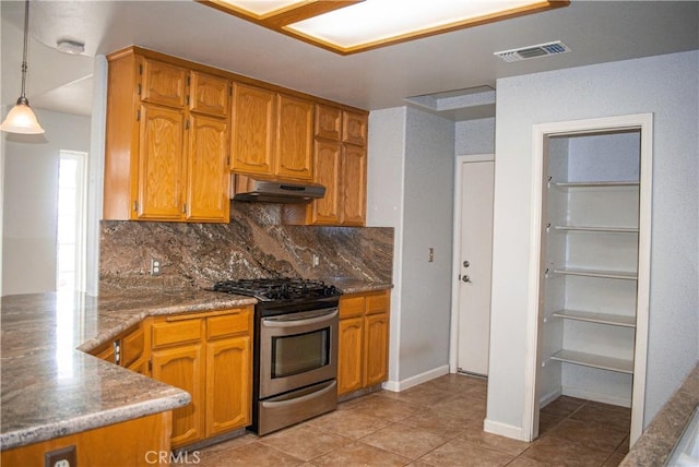 35777 Rd 606, Raymond, CA 93653 - kitchen featuring stainless steel gas range oven, under cabinet range hood, decorative backsplash, and brown cabinets