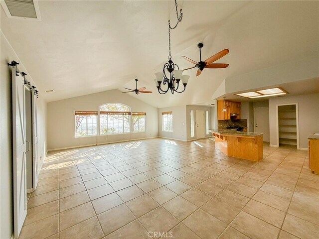 35777 Rd 606, Raymond, CA 93653 - unfurnished living room featuring vaulted ceiling, light tile patterned floors, ceiling fan, a chandelier, and baseboards