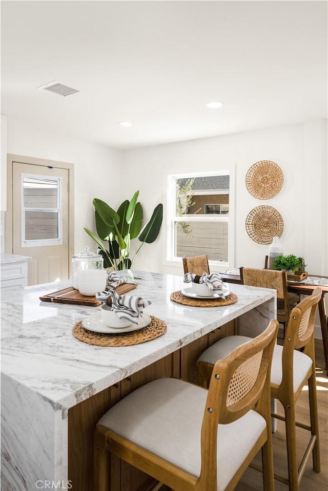 dining space featuring wood-type flooring