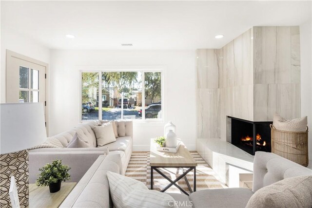 living room with a premium fireplace