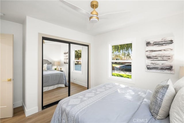 bedroom featuring light hardwood / wood-style flooring, a closet, and ceiling fan