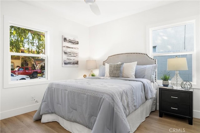 bedroom with light hardwood / wood-style floors and ceiling fan