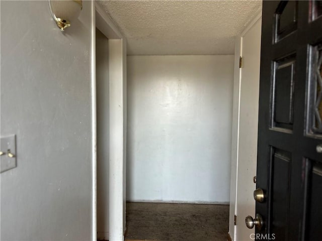 hallway featuring a textured ceiling