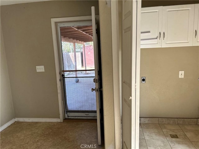 entryway with light tile patterned floors