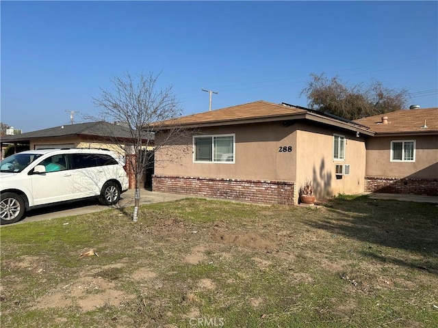 view of side of home featuring a lawn and cooling unit