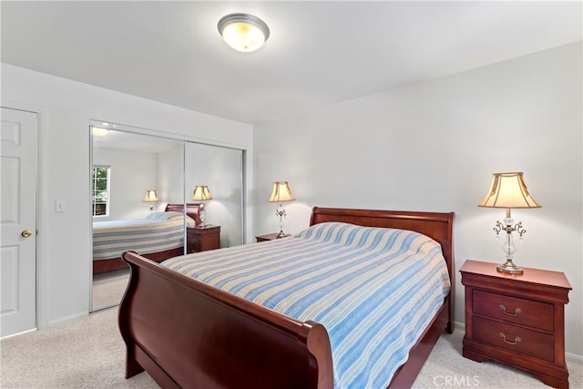 bedroom with light colored carpet and a closet