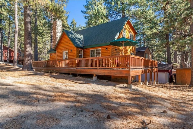 back of property with a wooden deck