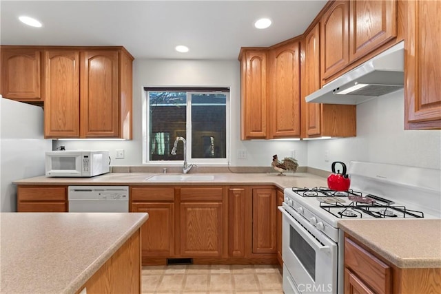 kitchen featuring white appliances and sink