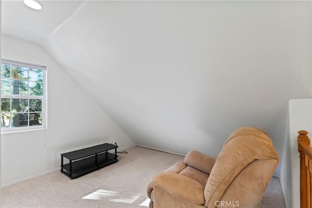 sitting room featuring light colored carpet and vaulted ceiling