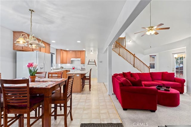 dining room featuring ceiling fan with notable chandelier