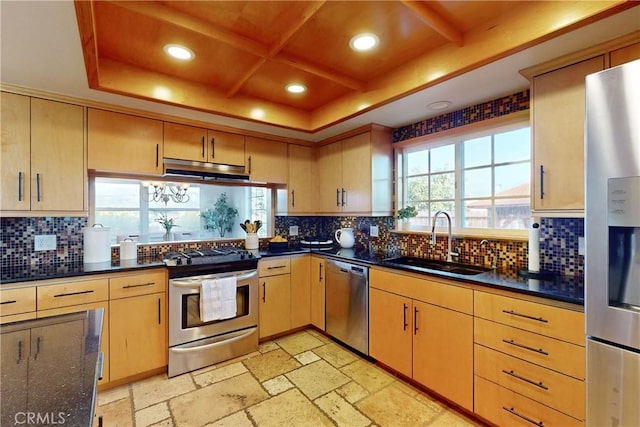 kitchen with coffered ceiling, appliances with stainless steel finishes, sink, and light brown cabinetry