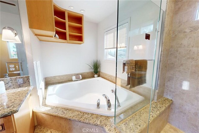 bathroom featuring vanity and shower with separate bathtub