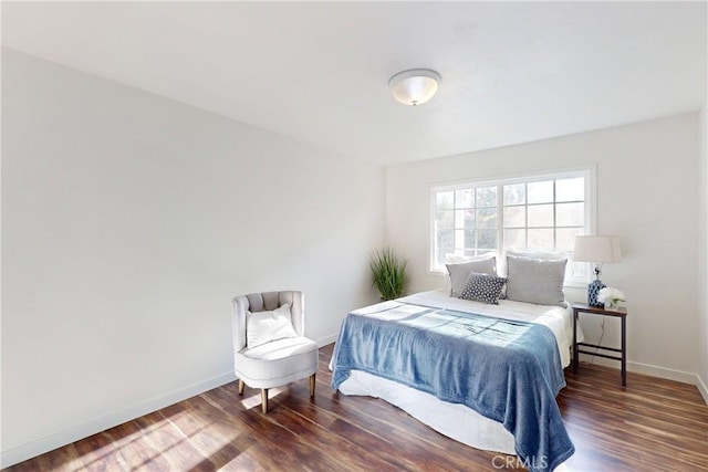 bedroom with dark wood-type flooring