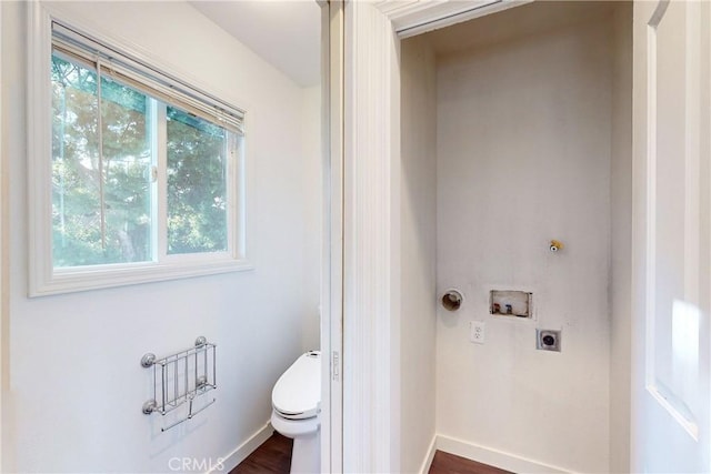 bathroom with toilet and hardwood / wood-style flooring